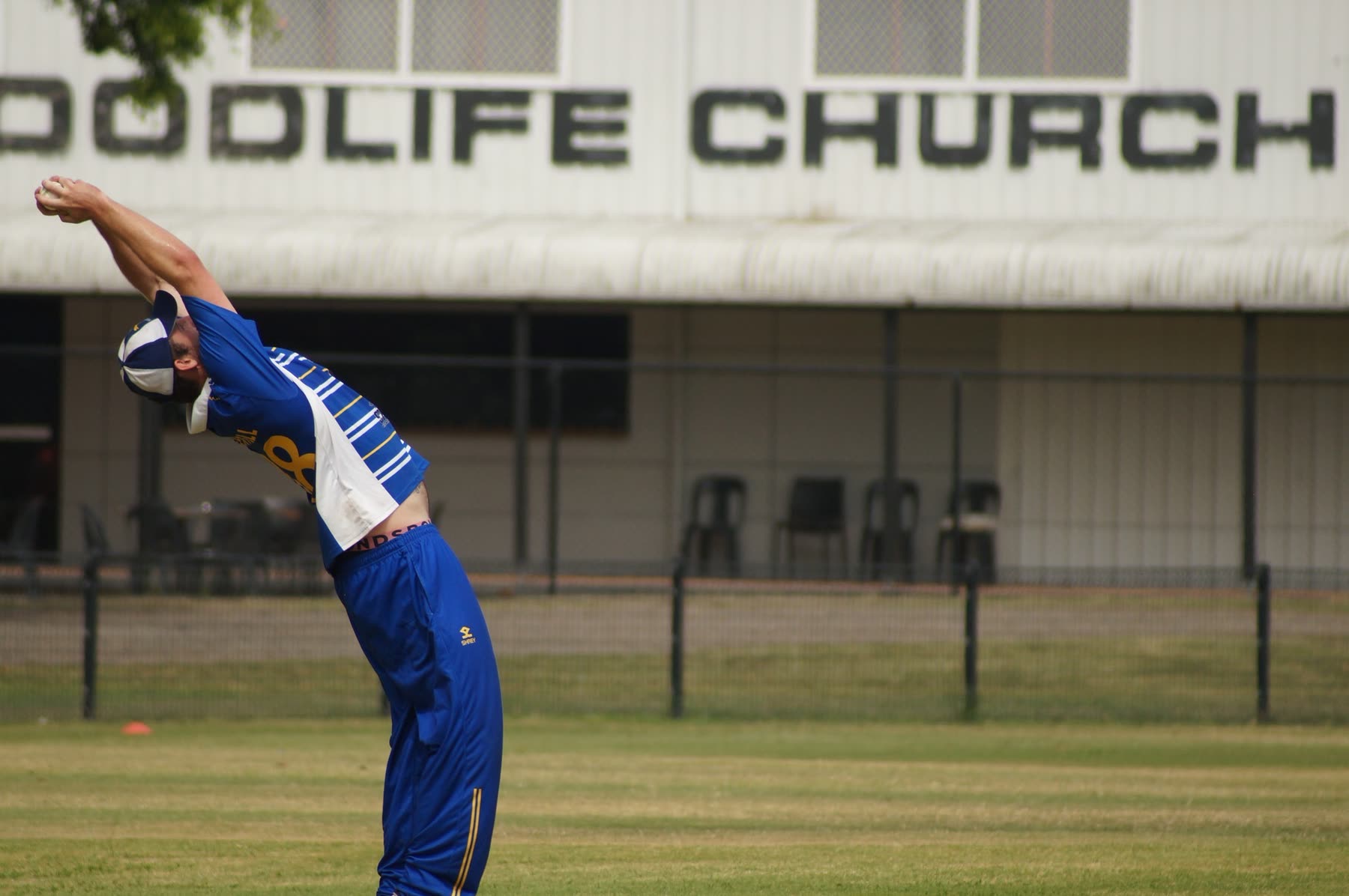 A Ham-Wicks bowler stretches before a spell