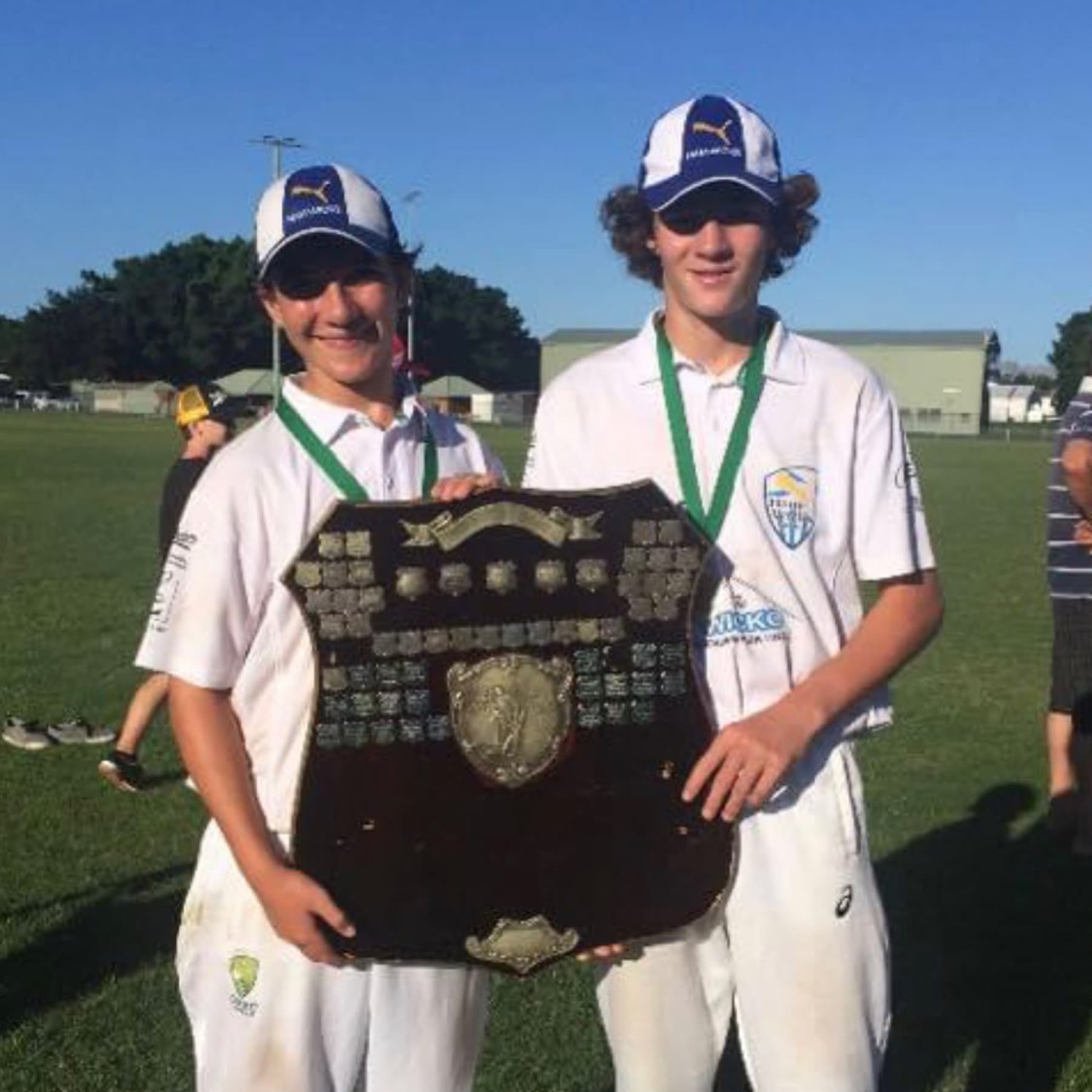 Two young Ham-Wicks Colts players holding a premiership shield