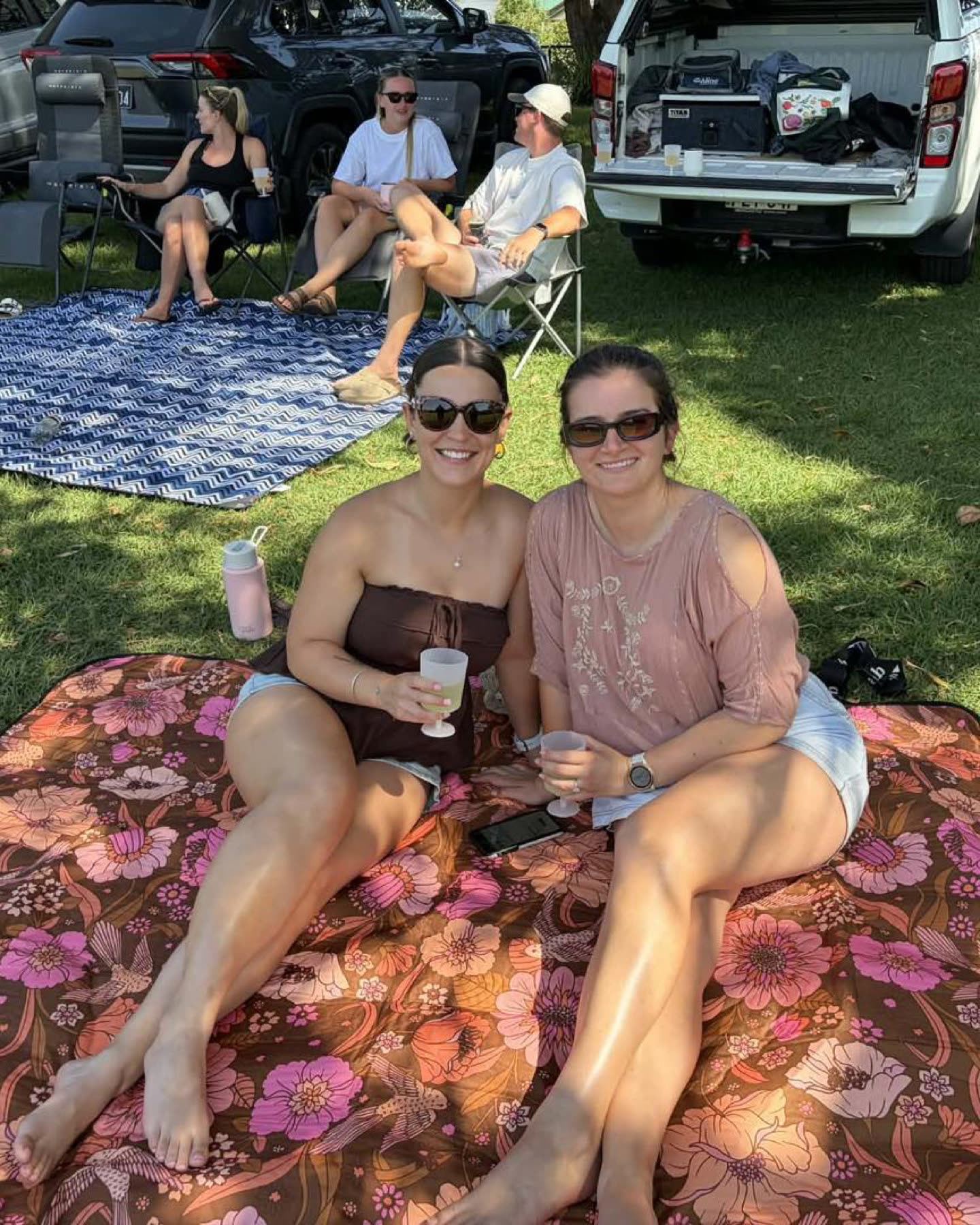 Two supporters on a picnic rug at Ladies Day