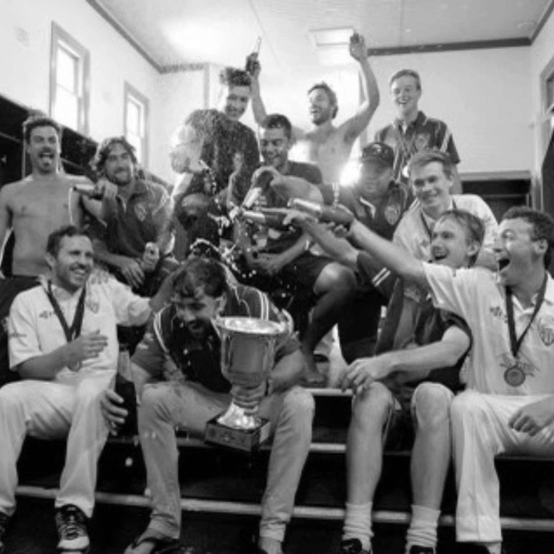 Ham-Wicks players celebrate a premiership with the cup in the sheds