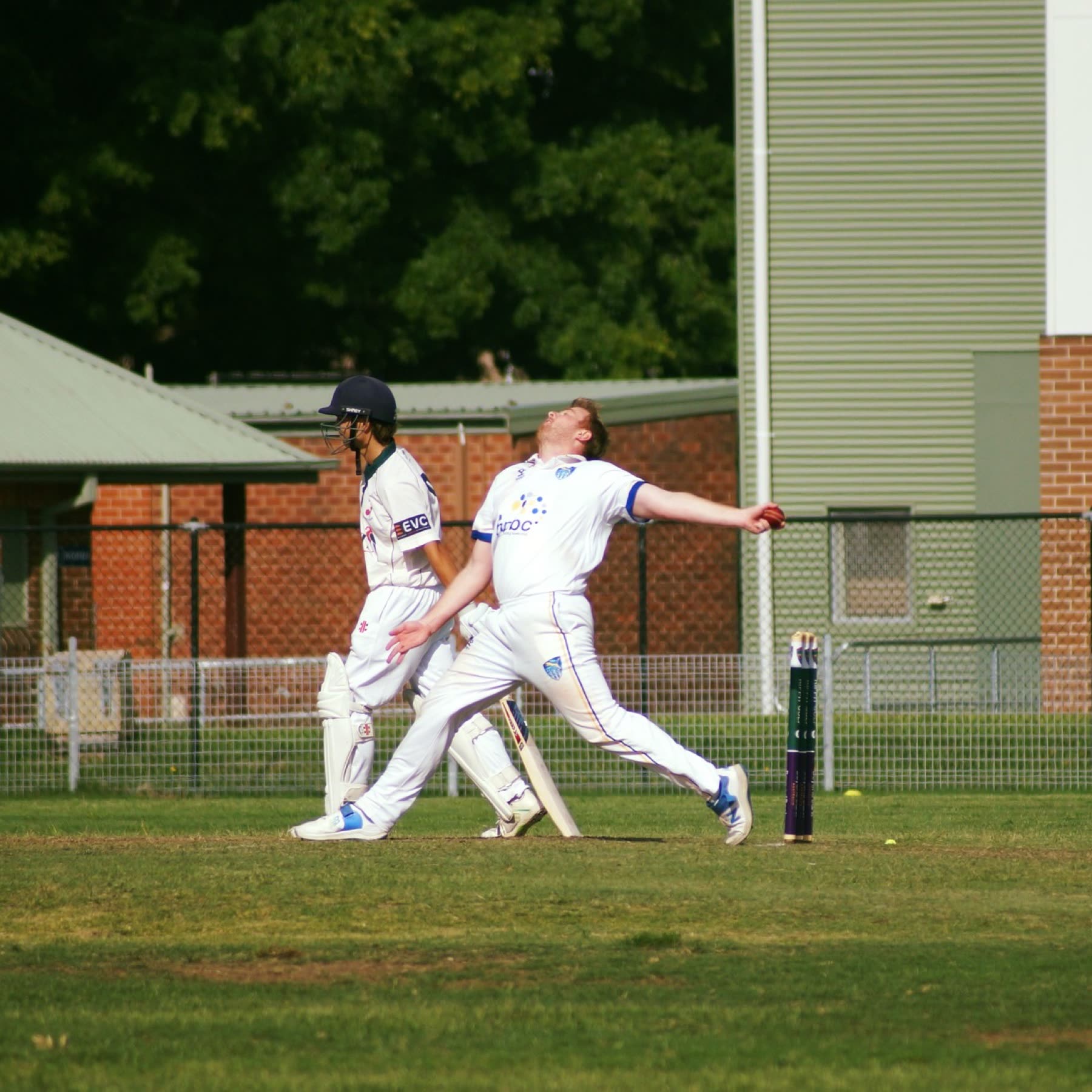 A bowler at the crease in whites