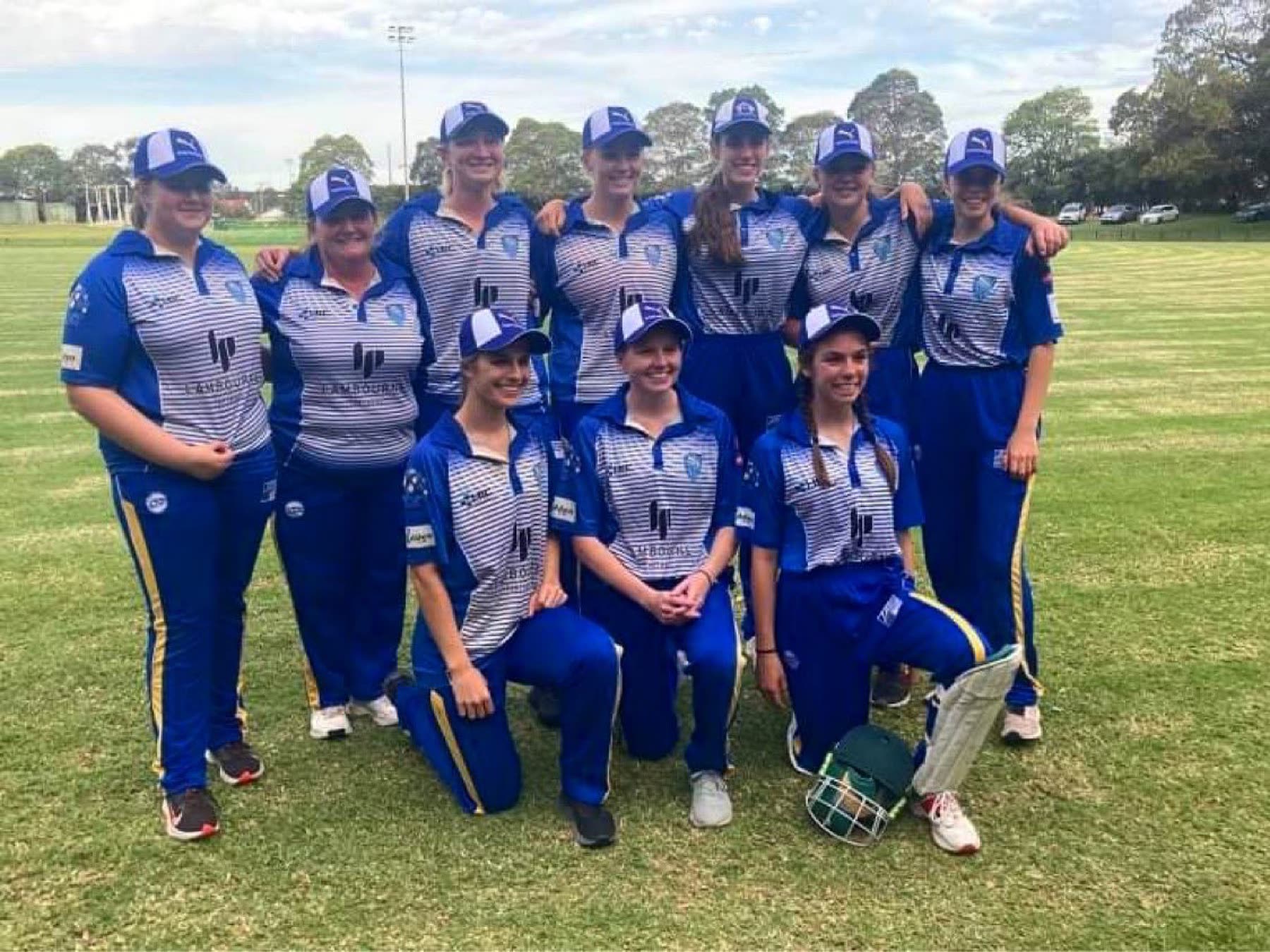 The Ham-Wicks women's team posing in caps after a game